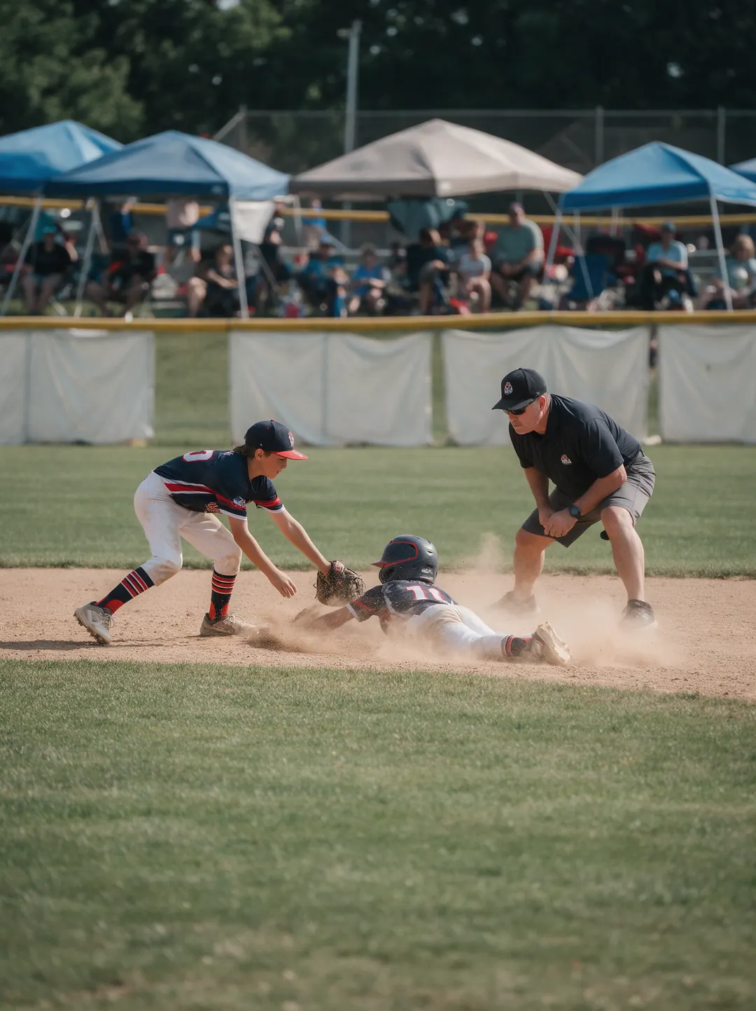 A runner sliding into second base as the shortstop puts the tag down